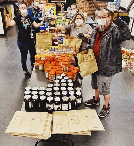 Chief Seattle Club staff pack groceries for Native communities in Seattle, Kent, and Federal Way