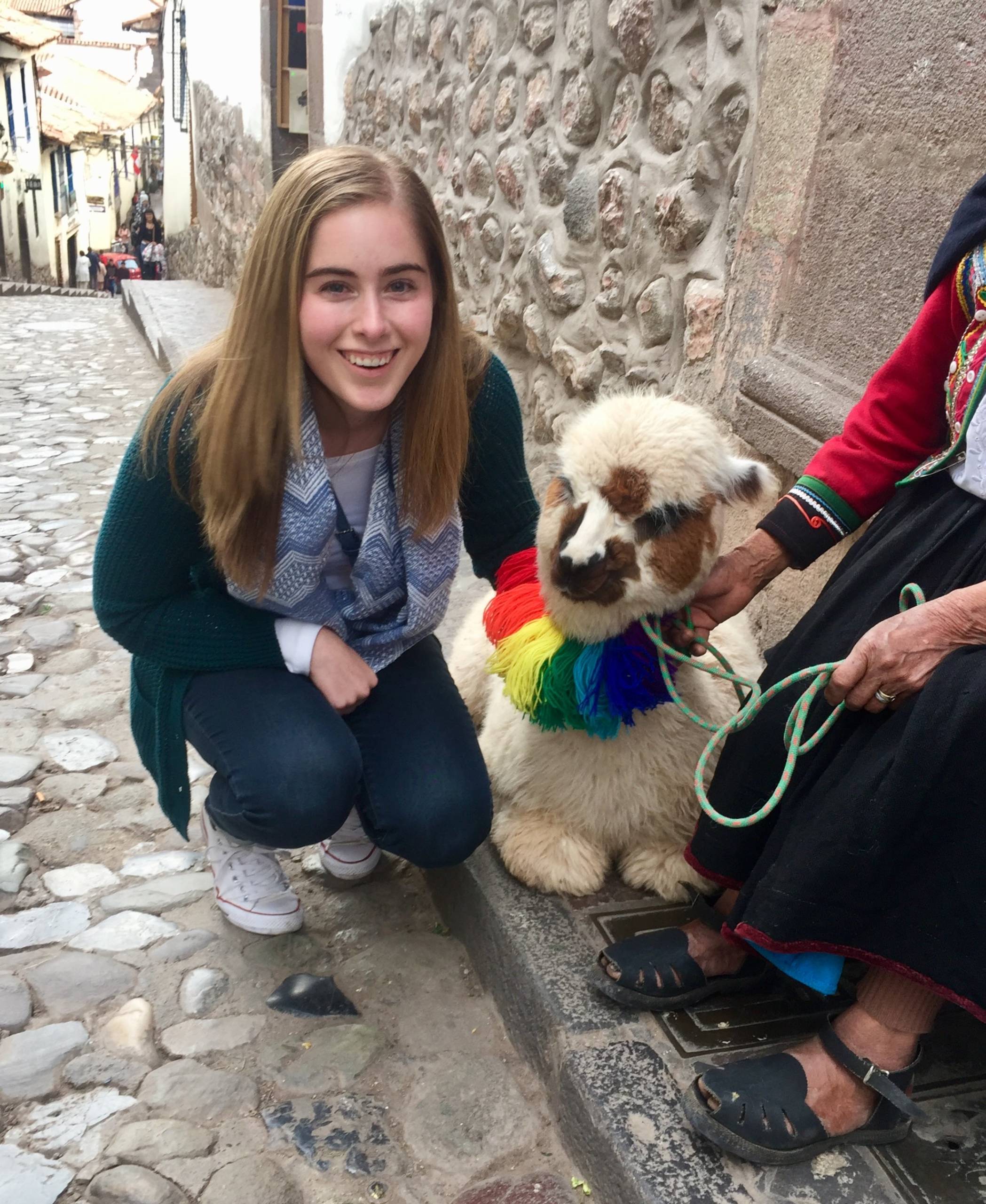 Julia says hello to a baby alpaca during a trip to Peru.