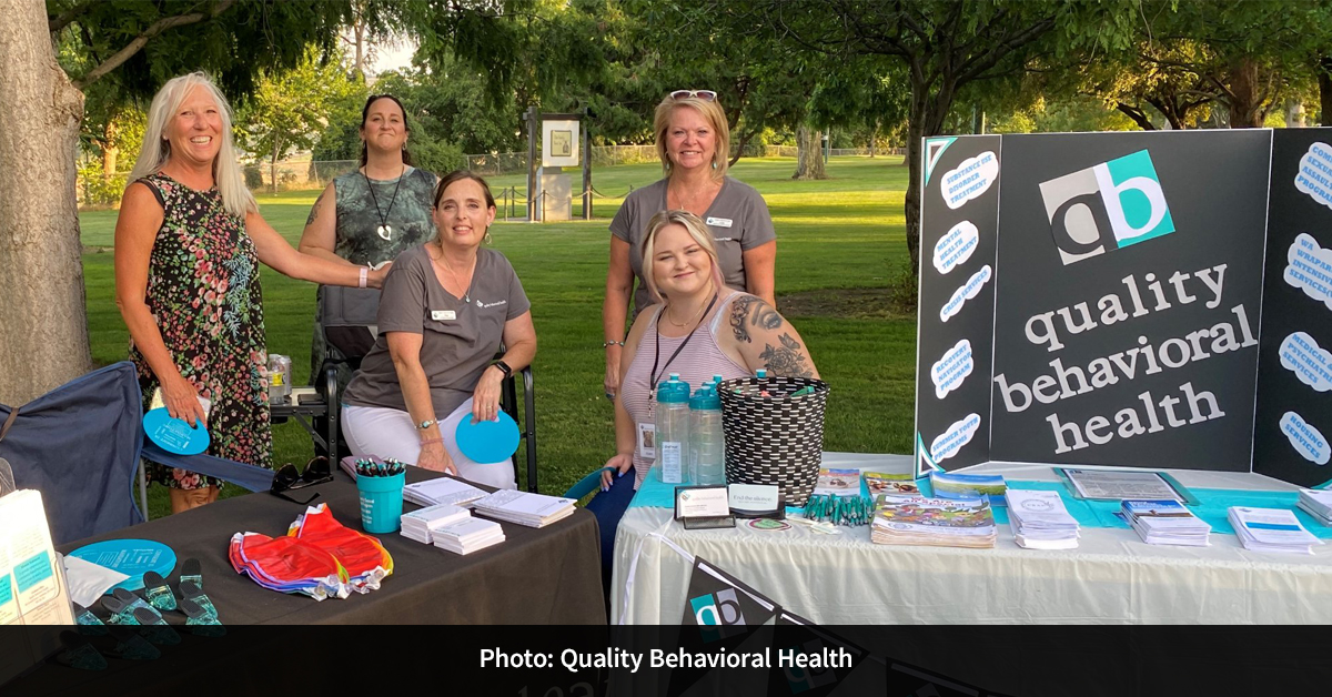 Five people tabling for Quality Behavioral Health.
